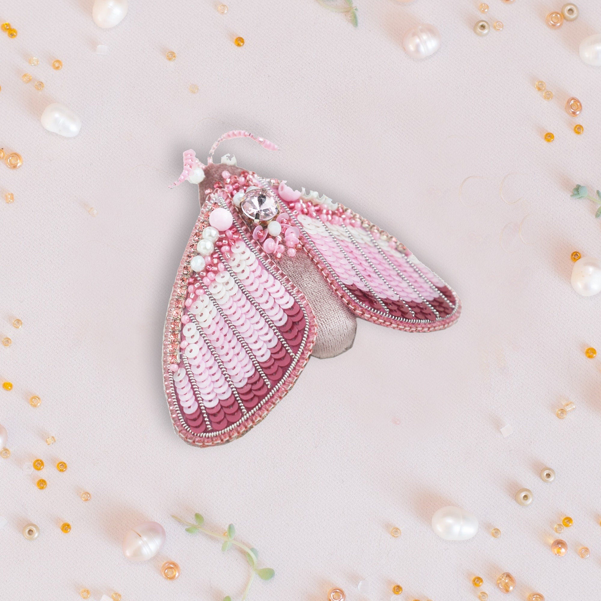a close up of a pink purse with pearls